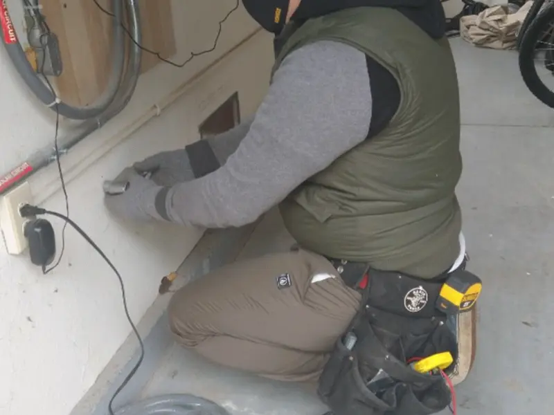 Electrician performing outlet wiring in a Limington garage